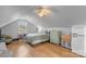 Cozy bedroom with wood floors and a vintage refrigerator at 8478 Rocky River Rd, Harrisburg, NC 28075