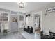 Bright entryway with tiled floor, bench, and whitewashed brick at 8478 Rocky River Rd, Harrisburg, NC 28075