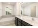 Modern bathroom with double vanity, soaking tub, and large mirror at 1218 Raelea Dr, Indian Trail, NC 28079