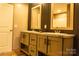 Double vanity bathroom with olive green cabinets and dark wood accents at 145 Eastgate Dr, Statesville, NC 28625