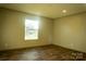 Bright bedroom with wood-look floors and large window at 145 Eastgate Dr, Statesville, NC 28625