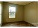 Bright bedroom with wood-look floors and large window at 145 Eastgate Dr, Statesville, NC 28625