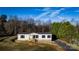 Single-story home with light beige siding, a brick base, and a covered deck at 145 Eastgate Dr, Statesville, NC 28625