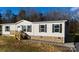 Ranch style home with light beige siding, gray shutters, and a brick base at 145 Eastgate Dr, Statesville, NC 28625