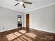 Hardwood floor bedroom with ceiling fan and door to bath at 1586 Kings Rd, Shelby, NC 28150