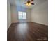 Bedroom with wood-look flooring, white walls, ceiling fan, and window at 17142 Red Feather Dr, Charlotte, NC 28277