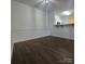 Dining area with breakfast bar, wood-look flooring, and modern light fixture at 17142 Red Feather Dr, Charlotte, NC 28277