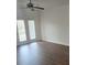 Bright living room with wood-look floors, white walls, and french doors to a patio at 17142 Red Feather Dr, Charlotte, NC 28277