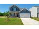 Two-story house with blue siding, brick accents, and a two-car garage at 185 Giant Oak Ave, Statesville, NC 28677