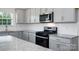 Granite countertops and stainless steel appliances in this modern kitchen at 185 Giant Oak Ave, Statesville, NC 28677