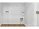Small laundry closet with wood flooring and shelving at 185 Giant Oak Ave, Statesville, NC 28677