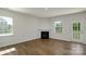 Living room with hardwood floors, gas fireplace, and access to backyard at 185 Giant Oak Ave, Statesville, NC 28677
