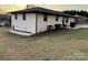 View of the backyard, chain-link fence, and a white brick wall at 206 Cavin Ave, Mount Holly, NC 28120