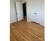 Bedroom featuring hardwood floors and white closet doors at 206 Cavin Ave, Mount Holly, NC 28120