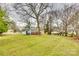 Spacious backyard with large tree and shed at 304 Durham Rd, Stanley, NC 28164