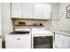 Bright laundry room with white cabinets and Maytag washer and dryer at 502 Berrybeth Cir, China Grove, NC 28023