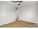 Bright bedroom with hardwood floors, neutral walls, and a ceiling fan at 5035 Auburndale Rd, Charlotte, NC 28205