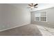 Bedroom featuring carpeting, ceiling fan, and ample natural light at 5622 Grey Dogwood Ct, Charlotte, NC 28269