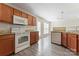 Bright kitchen boasts granite counters, white appliances, and wood cabinetry at 5622 Grey Dogwood Ct, Charlotte, NC 28269