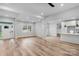 Open living room with wood-look floors and fireplace, leading to kitchen at 791 S Grove St, Lincolnton, NC 28092