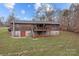 Back view of house with deck, stairs, and grassy yard at 101 Stonehenge Ln, Statesville, NC 28625