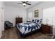 Cozy bedroom with blue and white bedding, wood furniture, and soft lighting at 112 Canina Ln, Indian Trail, NC 28079