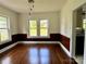 Dining room with wood paneling, hardwood floors, and large windows at 1201 Central Dr, Kannapolis, NC 28083