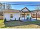 Charming white single-story home with covered porch and teal front door at 1235 Bradford Heights Rd, Gastonia, NC 28054