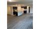 Open-concept kitchen and living area with wood-look flooring at 1305 Dodd St, Shelby, NC 28152