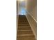 Carpeted staircase with white railing leading to the second floor at 1305 Dodd St, Shelby, NC 28152