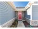 Red front door with stone accents and a welcoming mat at 139 Commerce Blvd, Lancaster, SC 29720