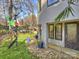 Backyard patio with seating area, colorful artwork, and lush landscaping at 1401 Scotland Ave, Charlotte, NC 28207