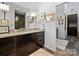Modern bathroom with dark wood cabinets, a sleek countertop, and a walk-in shower at 1401 Scotland Ave, Charlotte, NC 28207