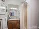 Bathroom with tiled shower/tub combo, vanity, and mirror at 1401 Scotland Ave, Charlotte, NC 28207