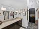 Modern bathroom with dark wood cabinets, sleek countertop, and artwork at 1401 Scotland Ave, Charlotte, NC 28207