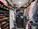Walk-in closet filled with organized clothing, shoes, and shelves at 1401 Scotland Ave, Charlotte, NC 28207