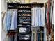 Organized closet with hanging clothes, shelves, and storage at 1401 Scotland Ave, Charlotte, NC 28207