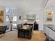 Dining area with large table, black leather chairs, and natural light from adjacent windows at 1401 Scotland Ave, Charlotte, NC 28207