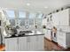 Spacious kitchen featuring white cabinetry, stainless steel appliances, and an island with cooktop at 1401 Scotland Ave, Charlotte, NC 28207