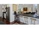 Kitchen with bar seating, wine rack, and view of the living area at 1401 Scotland Ave, Charlotte, NC 28207