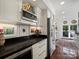 Kitchen features white cabinets, black countertops, and stainless steel appliances at 1401 Scotland Ave, Charlotte, NC 28207