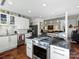 Open concept kitchen with view to dining/living area, white cabinetry, and a center island at 1401 Scotland Ave, Charlotte, NC 28207
