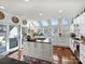 White kitchen with island, stainless steel appliances, and access to a patio at 1401 Scotland Ave, Charlotte, NC 28207