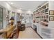 Bright home office with built-in bookshelves, desk, and windows at 1401 Scotland Ave, Charlotte, NC 28207