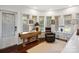 Home office with large windows, a recliner, and wooden desk at 1401 Scotland Ave, Charlotte, NC 28207