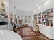 Home office with white built-in shelving, desk, and sitting area at 1401 Scotland Ave, Charlotte, NC 28207