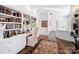 Bright home office with built-in bookshelves, desk, and area rug at 1401 Scotland Ave, Charlotte, NC 28207