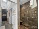 Walk-in shower with pebble floor and large dark tiled walls at 1401 Scotland Ave, Charlotte, NC 28207