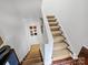 Carpeted staircase with white risers and modern artwork on the wall at 1401 Scotland Ave, Charlotte, NC 28207