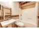 Bathroom with tiled shower, white sink and toilet, and decorative mirror at 319 Harvard Dr, Albemarle, NC 28001